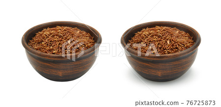 brown rice in clay bowl on white background, isolated and with shadow brown rice in clay bowl on white background, isolated and with shadow 76725873
