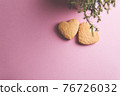 Two cookies in shape of a heart next to each other on a pink background. The concept of Valentine's Day. 76726032