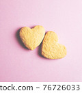 Two cookies in shape of a heart next to each other on a pink background. The concept of Valentine's Day. 76726033