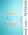 Words STOP CORONA from wooden letters, syringe and facemask. Vaccination and the end of epidemic concept. 76726048