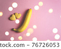 Two cookies in shape of a heart next to each other and banana on a pink background. The concept of Valentine's Day. 76726053