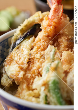 Bowl of rice and fried fish 76726540