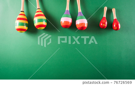 Cinco de Mayo holiday background made from maracas on green background. 76726569