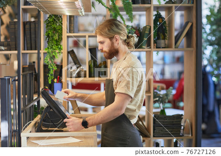 Bearded Man Using Cash Register in Cafe Bearded Man Using Cash Register in Cafe 76727126