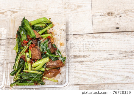 crispy pork belly on topped rice - Asian food style.Asian street food on wooden floor, Thai food 76728339