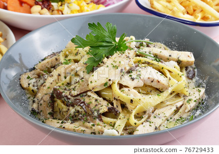 Wide noodles with chicken, truffle mushroom, butter, and cream sauce 76729433