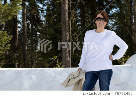White sweatshirt mockup of a woman in the winter forest White sweatshirt mockup of a woman in the winter forest 76731493