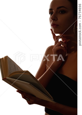 female silhouette reading pensive woman with book 76734698