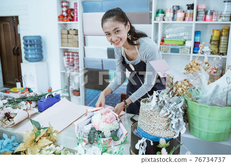 smiling woman florist working in flower shop make order flannel flower smiling woman florist working in flower shop make order flannel flower 76734737