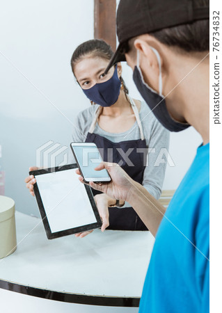 portrait young female shopkeeper serve customer qr barcode with protocol healthy portrait young female shopkeeper serve customer qr barcode with protocol healthy 76734832