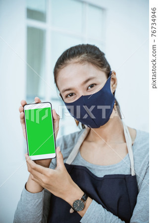 close up florist woman shopkeeper holding phone showing qris barcode close up florist woman shopkeeper holding phone showing qris barcode 76734946