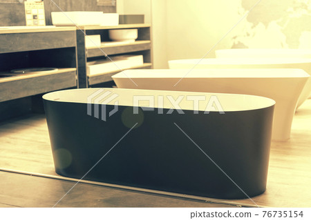 Black bathtub at a hardware store. Sanitary engineering shop. toned Black bathtub at a hardware store. Sanitary engineering shop. toned 76735154
