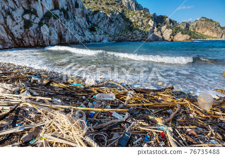 Trash on the beach 76735488
