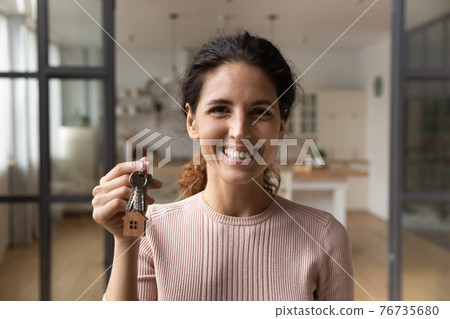 Portrait of lucky young lady winning new flat in lottery Portrait of lucky young lady winning new flat in lottery 76735680