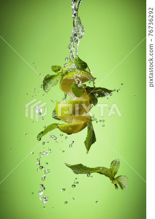 Fresh lime, mint, and ice in a splash. Fresh lime, mint, and ice in a splash. 76736292