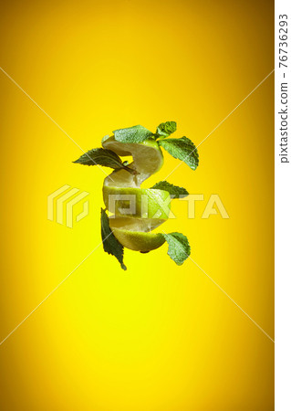 Fresh lime and mint on a yellow background. Fresh lime and mint on a yellow background. 76736293