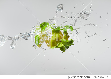 Fresh lime, mint, and ice in a splash. Fresh lime, mint, and ice in a splash. 76736294
