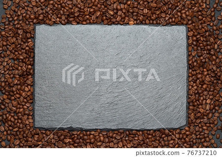 Background or texture made of roasted brown coffee beans and stone serving board Background or texture made of roasted brown coffee beans and stone serving board 76737210