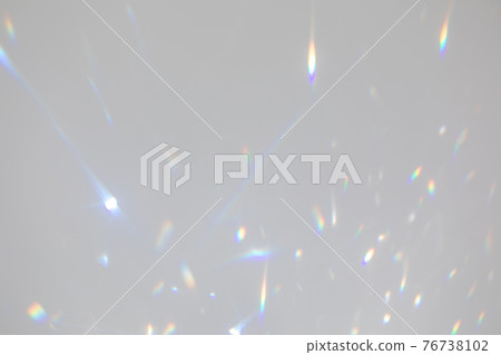 Blurred rainbow light refraction texture on white wall 76738102