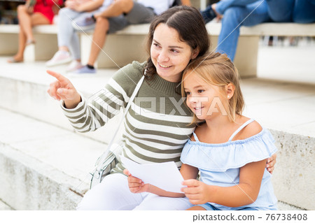 Mother and daughter looking at sight during sightseeing tour Mother and daughter looking at sight during sightseeing tour 76738408