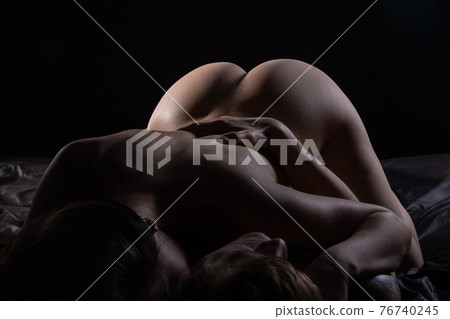 Photo of naked female hips on man in shadows 76740245