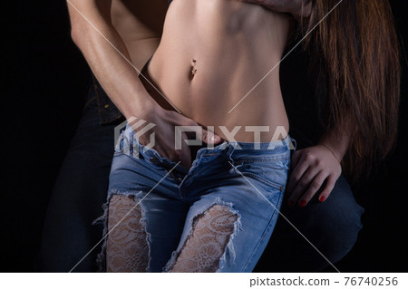 Shot of man undressing woman in shadows 76740256