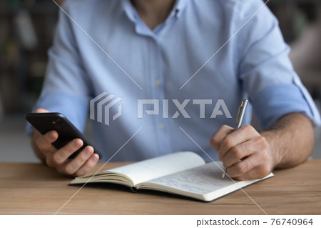 Close up of man handwrite using modern smartphone Close up of man handwrite using modern smartphone 76740964