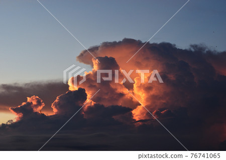 Cumulonimbus cloud formations on tropical sky with horizon is turning yellow at sunset , Nimbus moving , Purple and orange color clouds hunk at night , Thailand Cumulonimbus cloud formations on tropical sky with horizon is turning yellow at sunset , Nimbus moving , Purple and orange color clouds hunk at night , Thailand 76741065