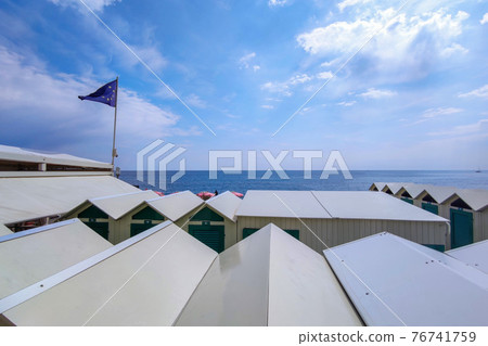 Bathhouse beach club preparation set up for summer season in Italy 76741759