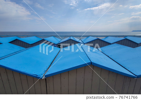 Bathhouse beach club preparation set up for summer season in Italy 76741766