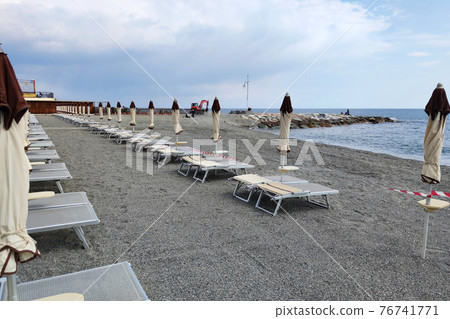 Bathhouse beach club preparation set up for summer season in Italy 76741771