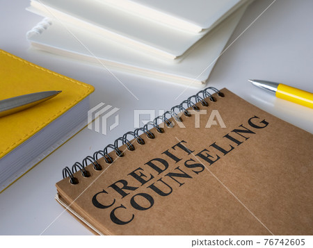 Credit counseling notepad on the white desk. 76742605
