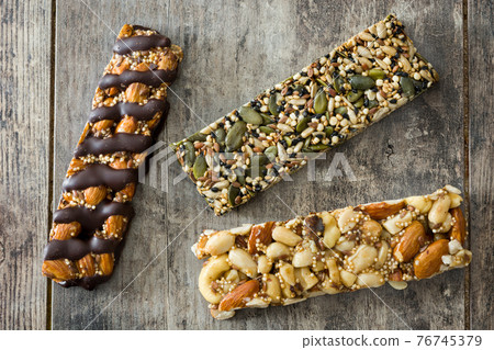 Muesli bars on wooden table 76745379
