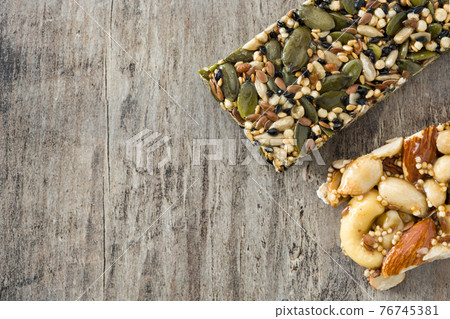 Muesli bars on wooden table 76745381