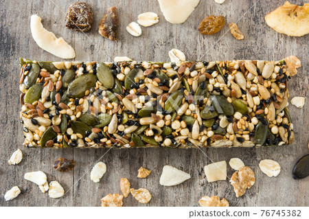 Muesli bars on wooden table 76745382