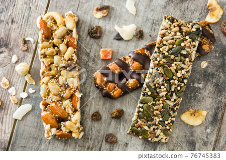 Muesli bars on wooden table 76745383