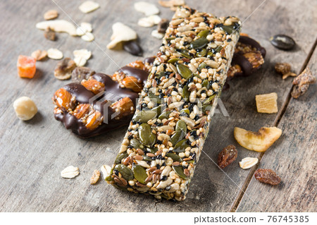Muesli bars on wooden table 76745385