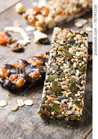Muesli bars on wooden table 76745386