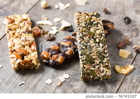 Muesli bars on wooden table 76745387