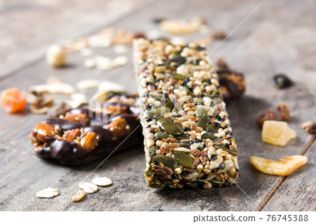 Muesli bars on wooden table 76745388