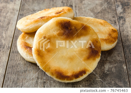 Arepas on wooden table. Venezuelan typical food 76745463