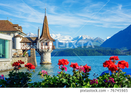 Oberhofen castle on Lake Thun, Switzerland, Alps mountains 76745985