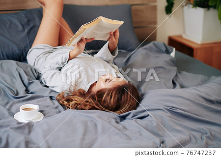 Woman enjoying good book 76747237