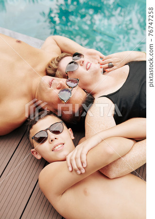Sunbathing happy family 76747258