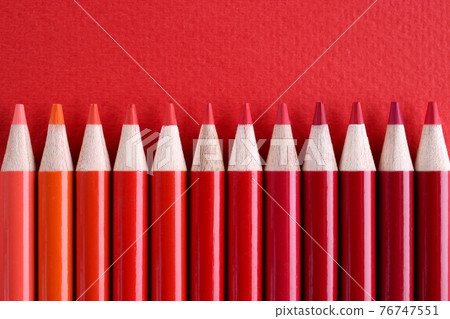 Closeup of many shades of red wooden pencils 76747551