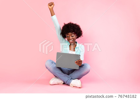Joyful Black Lady With Laptop Shaking Fists On Pink Background Joyful Black Lady With Laptop Shaking Fists On Pink Background 76748182