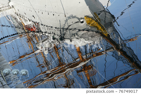 Sailing ship and blue sky reflected on the surface of the water Sailing ship and blue sky reflected on the surface of the water 76749017