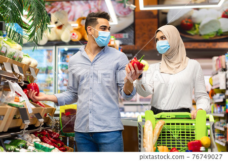 Muslim Family Buying Vegetables During Grocery Shopping In Supermarket Muslim Family Buying Vegetables During Grocery Shopping In Supermarket 76749027