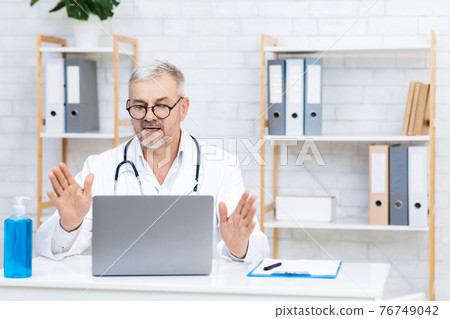 Online modern consultation with doctor in clinic during social distance and covid-19 pandemic 76749042