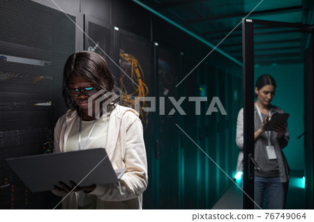 Young African American Woman Working in Data Center 76749064